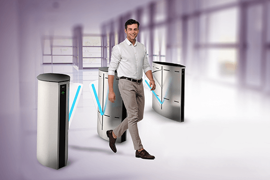 Employee walking through biometric-enabled flap barrier at office entrance, representing access and attendance management – ScreenCheck,
